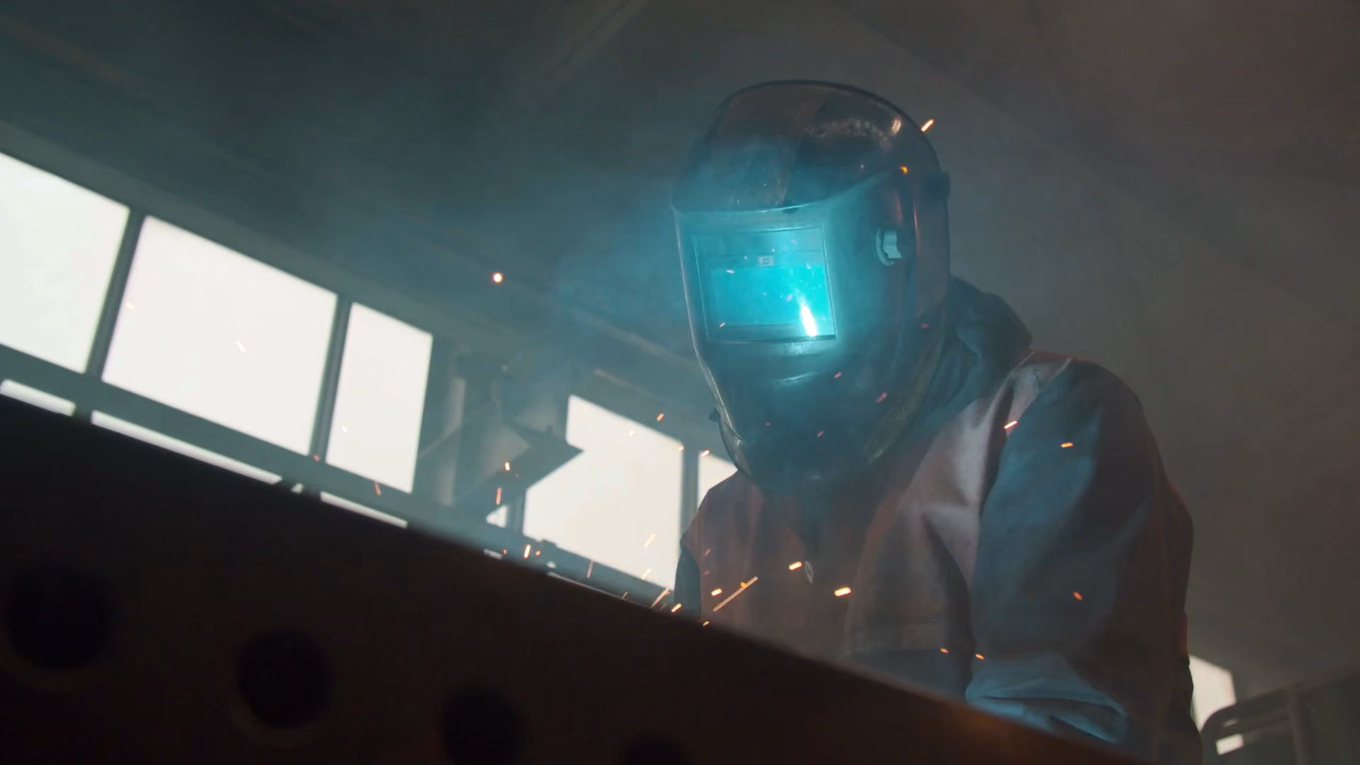 A welder in a shower of sparks, stock footage with sound effects timed to the sparks