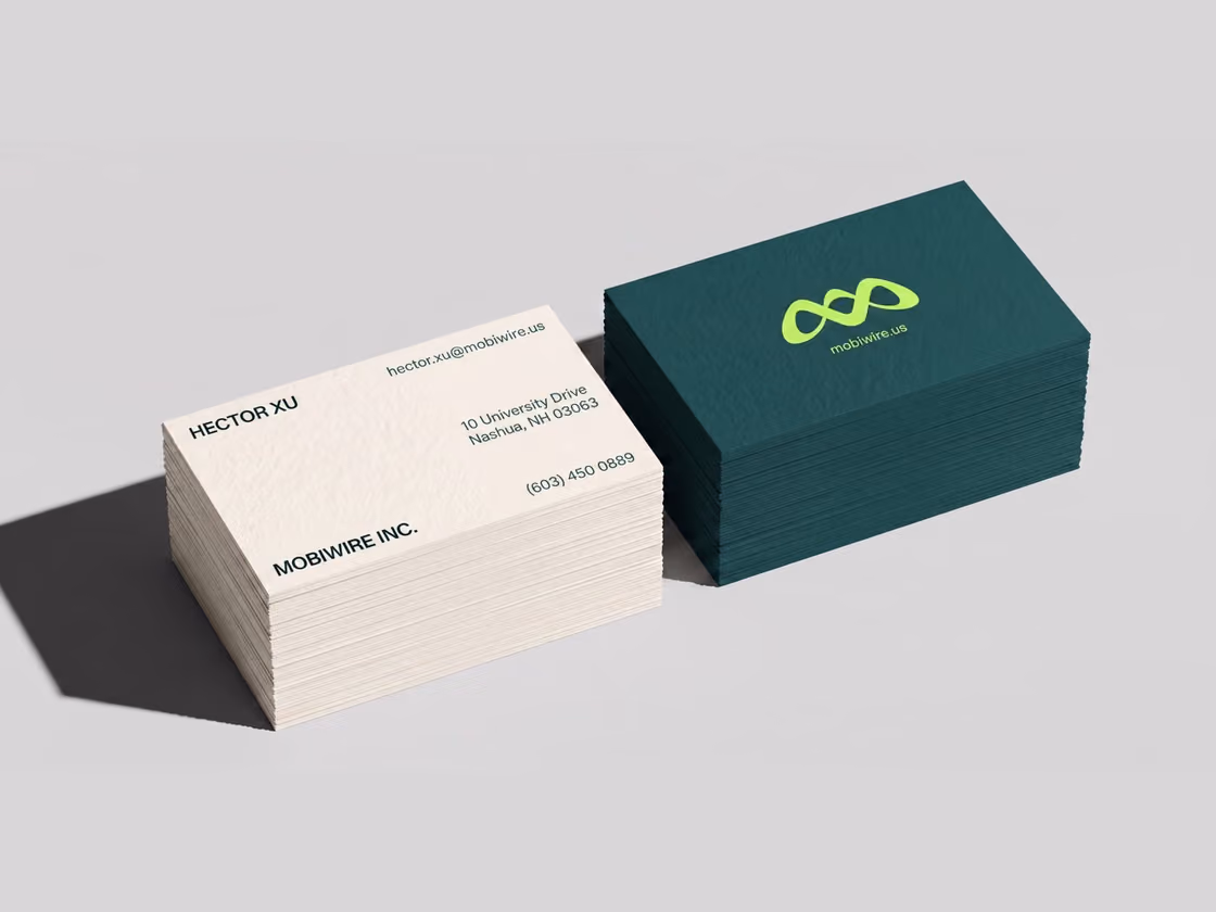 MobiWire business cards, a cream card and a deep green card with a lime mark
